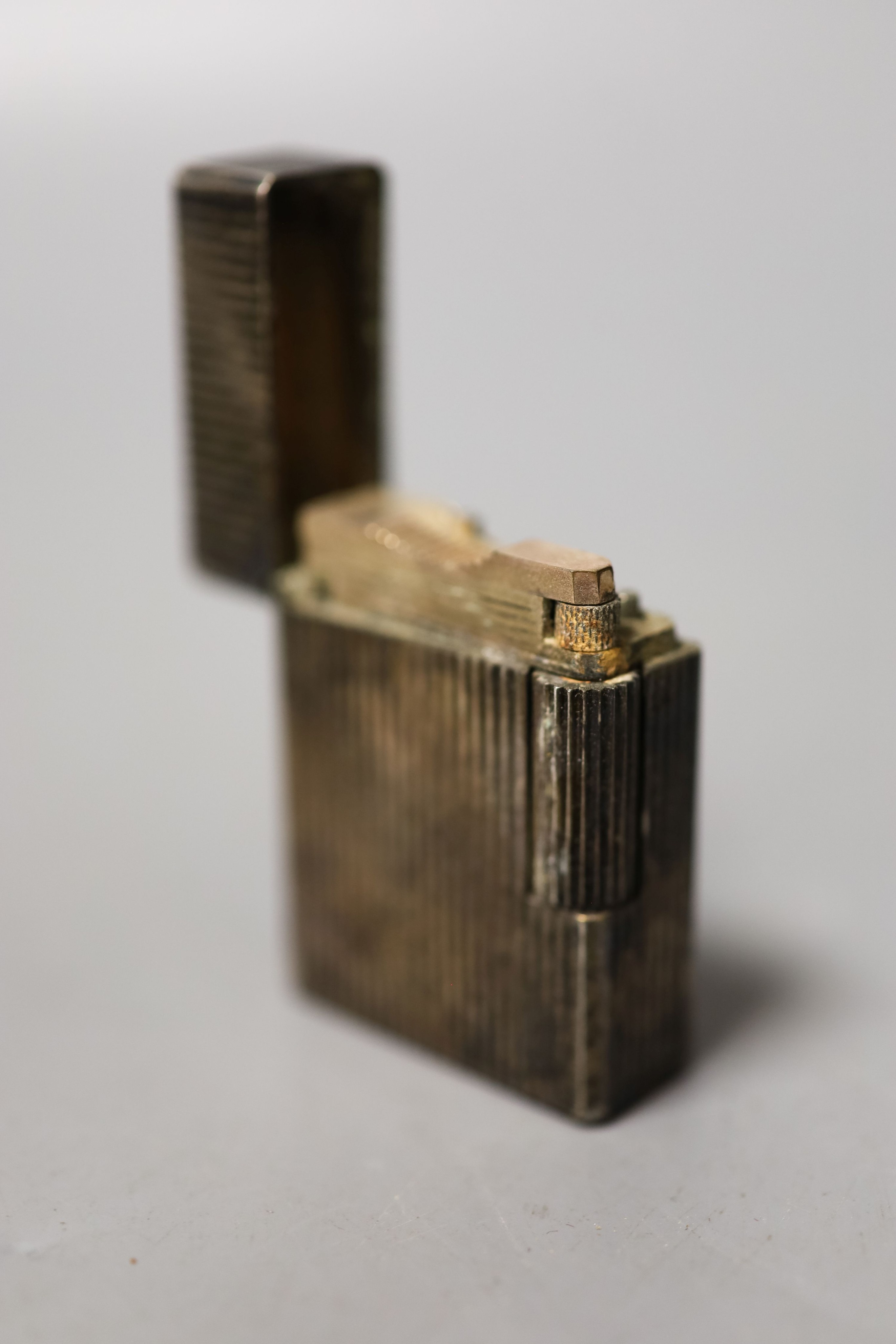 A 20th century Egyptian white metal brandy pan, a plated Dupont lighter, double measure and compact.